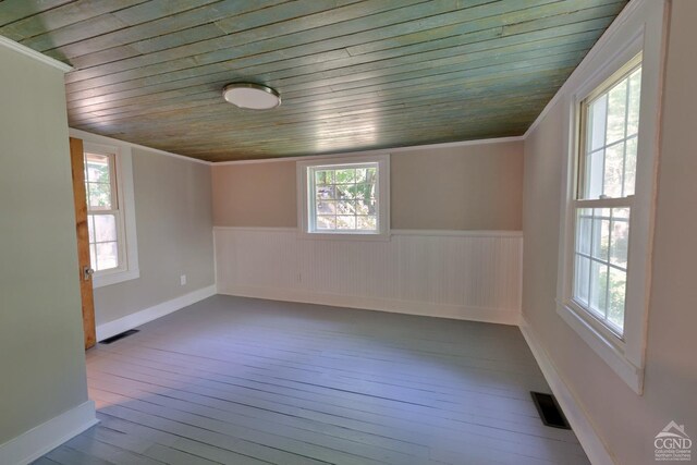 empty room with wooden ceiling, crown molding, and wood-type flooring