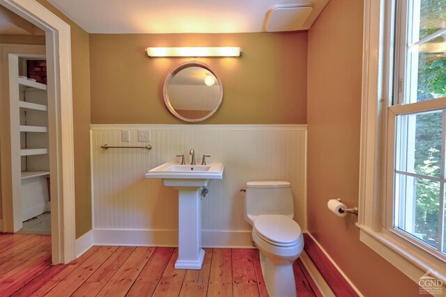 bathroom featuring hardwood / wood-style floors and toilet