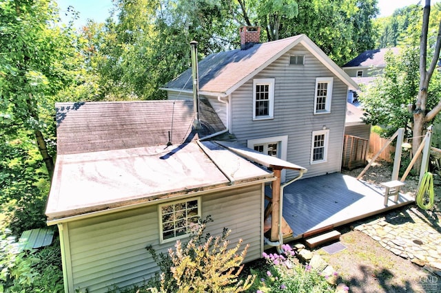 rear view of house featuring a wooden deck