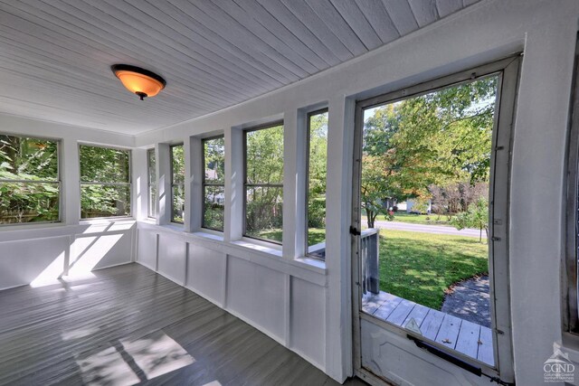 unfurnished sunroom with wooden ceiling