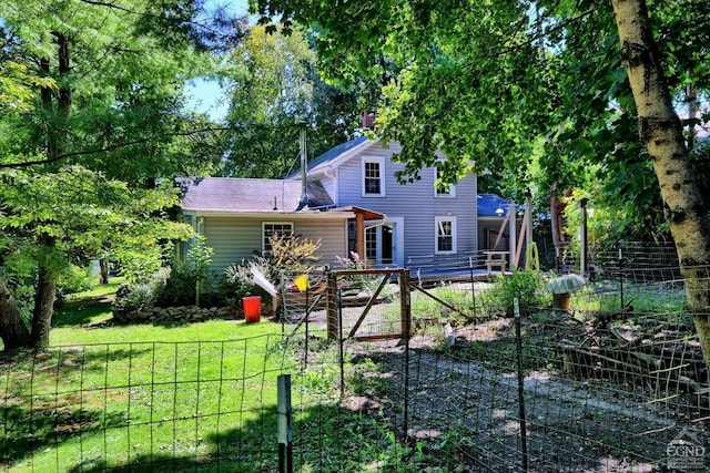 rear view of house with a lawn