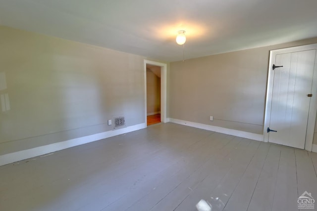 spare room with hardwood / wood-style floors