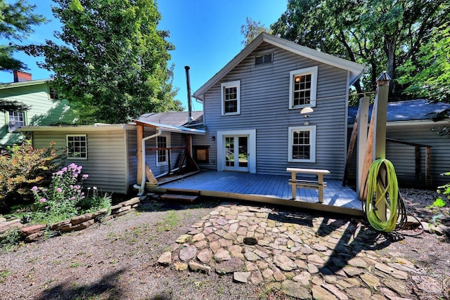 rear view of property with french doors and a deck