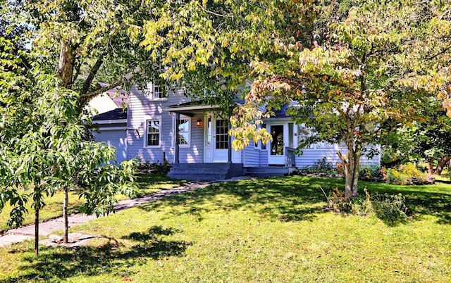 view of property hidden behind natural elements with a front lawn