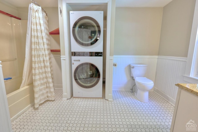 laundry room with stacked washer / drying machine