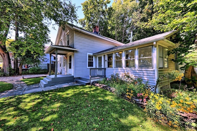 view of front of house featuring a front yard and a sunroom