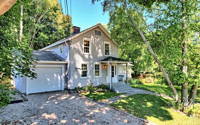 front facade featuring a front lawn and a garage