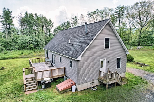 back of property featuring a lawn and a deck