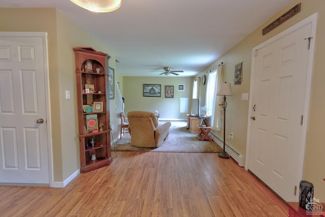 unfurnished living room featuring ceiling fan and light hardwood / wood-style floors