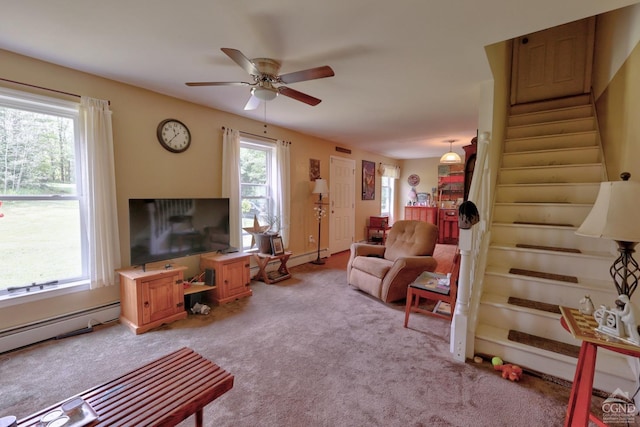 carpeted living room featuring ceiling fan and a baseboard heating unit