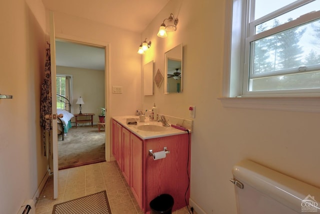 bathroom with tile patterned floors, toilet, vanity, and a baseboard heating unit