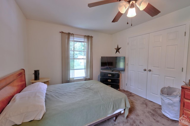 carpeted bedroom featuring ceiling fan and a closet