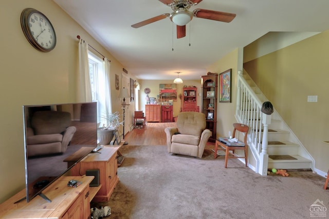 carpeted living room featuring ceiling fan