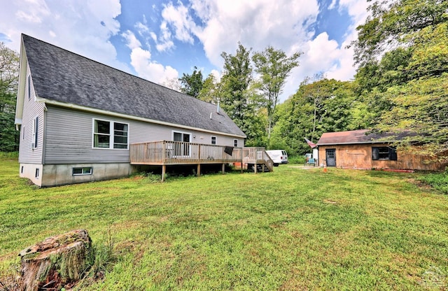 back of property with a lawn and a deck