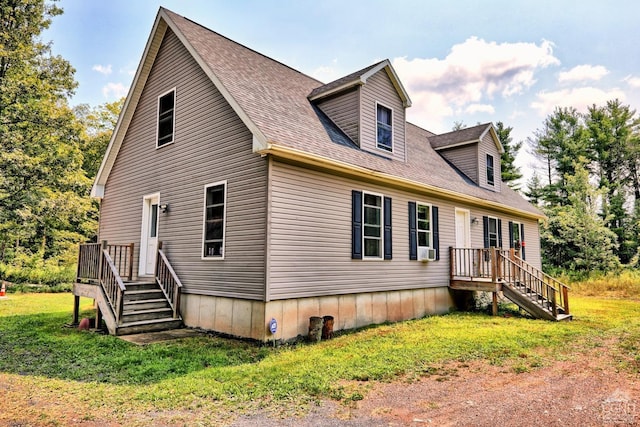 view of front of property featuring cooling unit and a front lawn