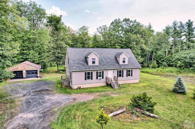 new england style home with an outbuilding, a garage, and a front yard