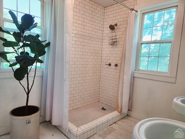 bathroom with walk in shower and a wealth of natural light