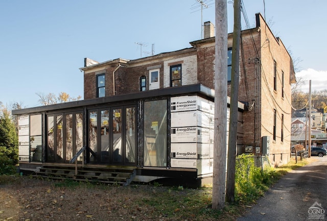 back of house with a sunroom