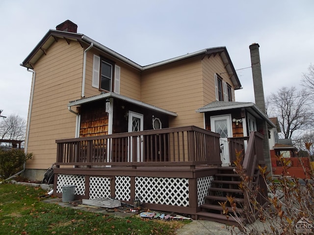 rear view of property featuring a deck