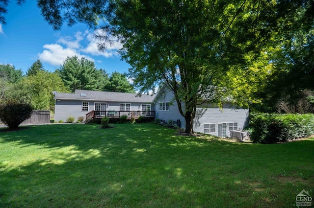 exterior space featuring a yard and a wooden deck