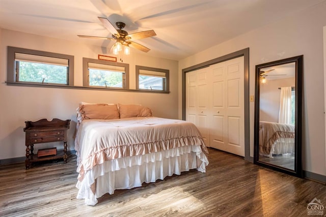 bedroom with ceiling fan, wood-type flooring, and a closet