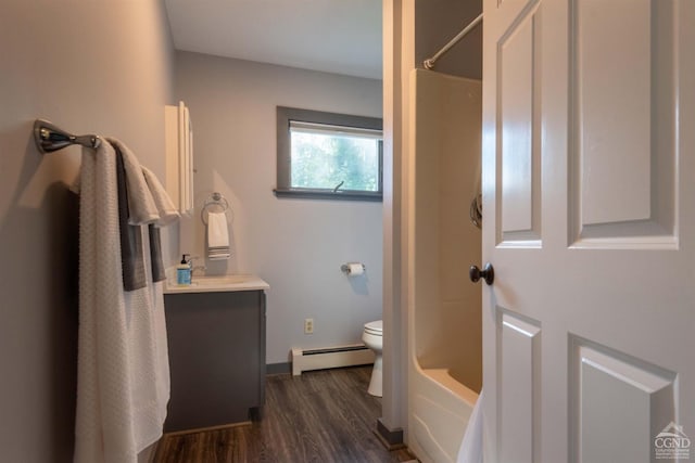 full bathroom with bathing tub / shower combination, toilet, baseboard heating, hardwood / wood-style floors, and vanity