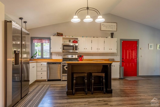 kitchen with white cabinetry, stainless steel appliances, and decorative light fixtures