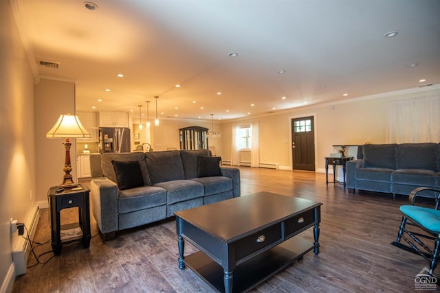 living room with crown molding, dark hardwood / wood-style flooring, and a baseboard heating unit