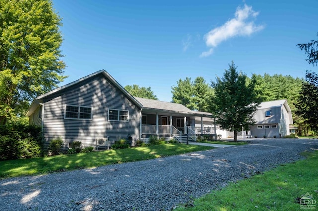 ranch-style house with a front yard, a garage, and a porch