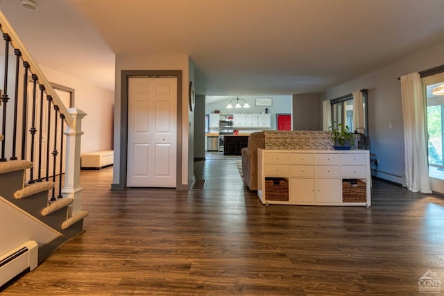 kitchen with baseboard heating, dark wood-type flooring, and appliances with stainless steel finishes