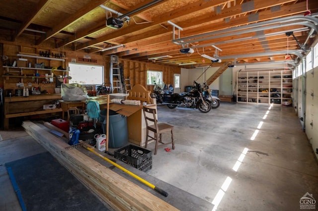 garage featuring a garage door opener and a workshop area