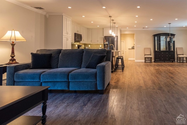 living room with crown molding and hardwood / wood-style floors