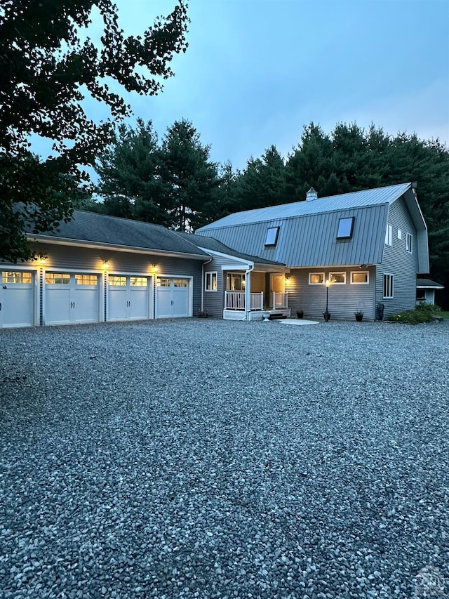 view of front of property featuring covered porch and a garage