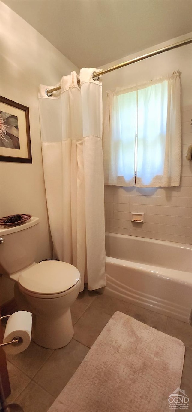 full bathroom with toilet, shower / bath combination with curtain, and tile patterned flooring