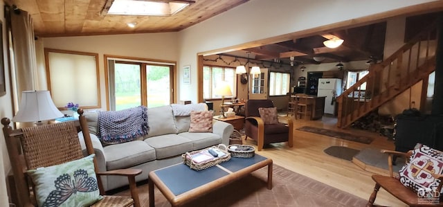 living area featuring stairway, wooden ceiling, vaulted ceiling, and wood finished floors