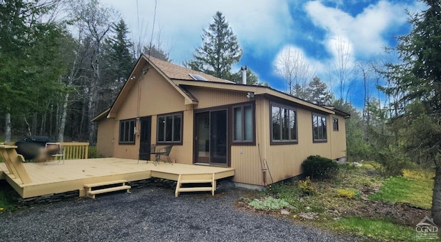 back of house featuring a deck