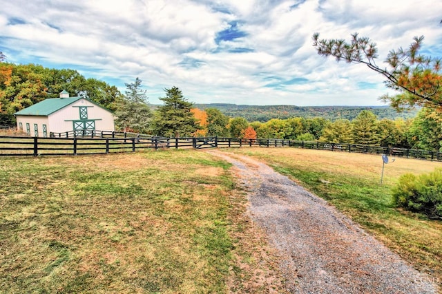 view of yard with a rural view and an outdoor structure