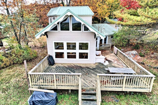 rear view of property featuring a wooden deck