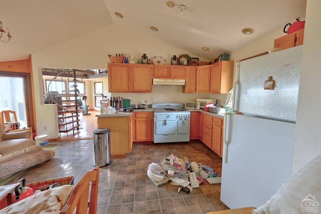 kitchen with tile countertops, white appliances, light brown cabinetry, and vaulted ceiling