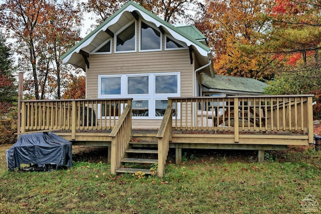 rear view of house with a wooden deck