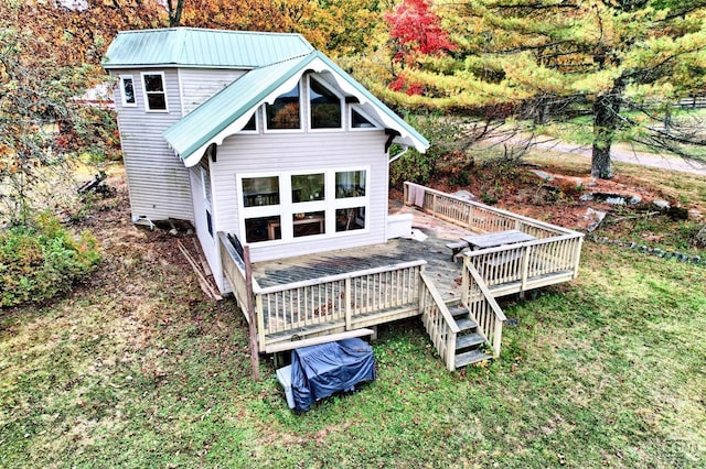 back of property featuring a yard and a wooden deck