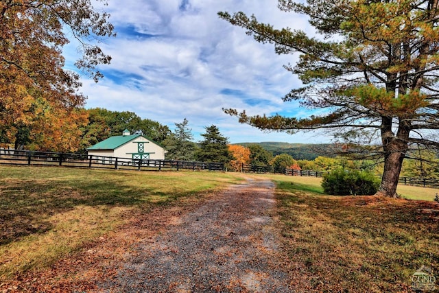 view of yard with a rural view and an outbuilding