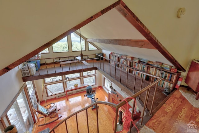 stairs with wood-type flooring and high vaulted ceiling