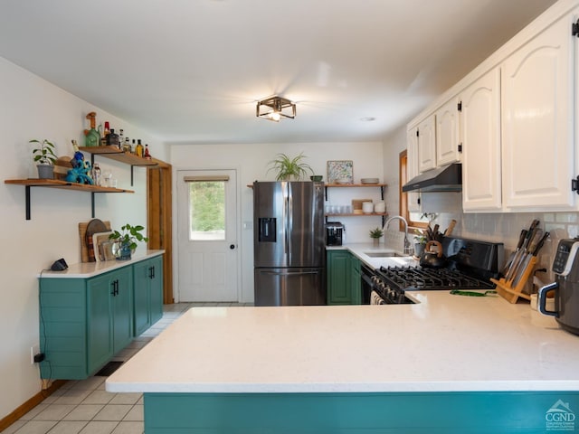 kitchen featuring kitchen peninsula, stainless steel refrigerator with ice dispenser, black range with gas cooktop, sink, and white cabinetry