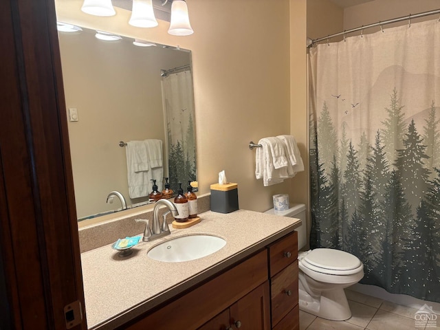 bathroom featuring vanity, tile patterned floors, and toilet