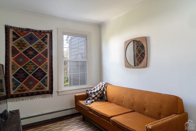 sitting room featuring baseboard heating, hardwood / wood-style floors, and ornamental molding