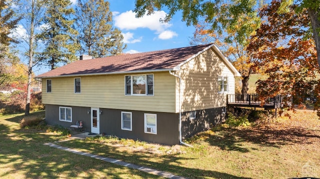 exterior space with a wooden deck and a front lawn