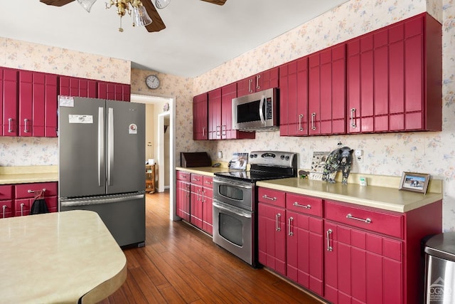 kitchen with dark hardwood / wood-style floors, ceiling fan, and appliances with stainless steel finishes