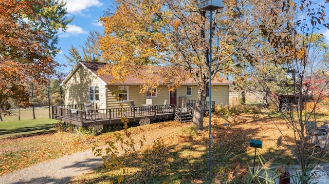 view of front of house featuring a front yard and a wooden deck