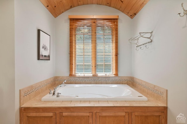 bathroom with a bath and lofted ceiling